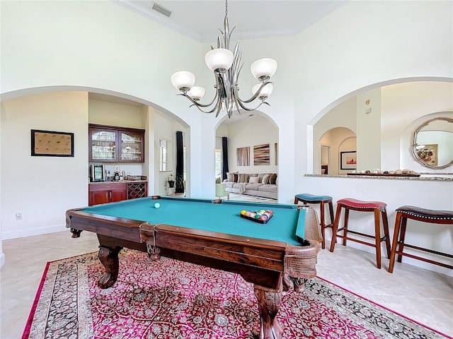 game room with a chandelier, bar, a towering ceiling, billiards, and ornamental molding