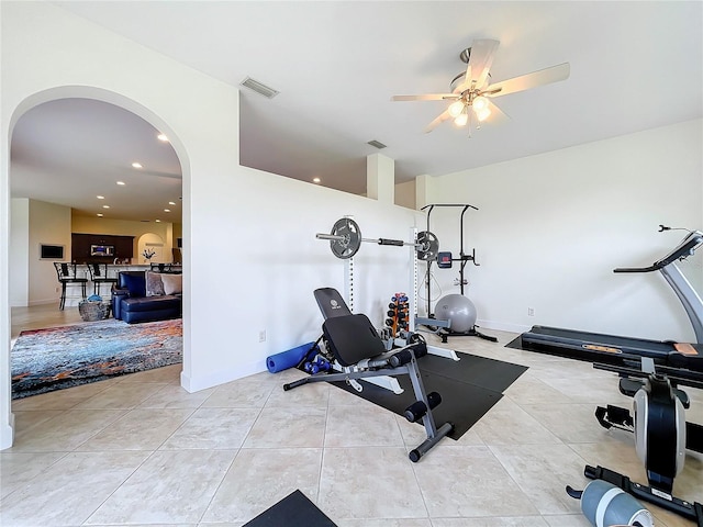 workout room featuring ceiling fan and light tile patterned floors