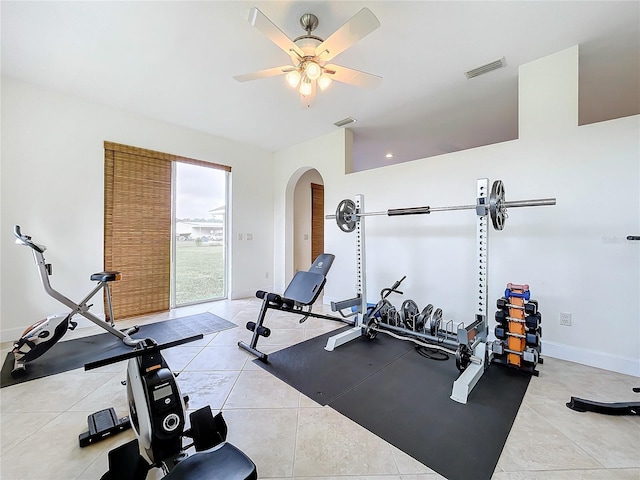 exercise room with ceiling fan and light tile patterned floors