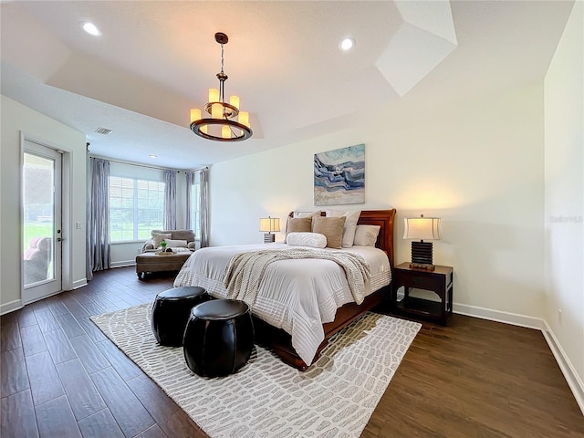 bedroom with access to outside, dark hardwood / wood-style flooring, and a notable chandelier