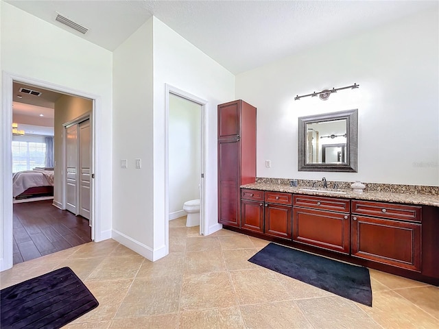 bathroom featuring vanity, toilet, and hardwood / wood-style flooring