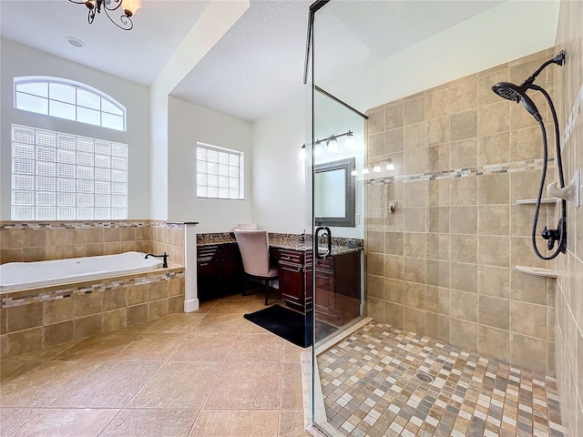 bathroom featuring shower with separate bathtub, tile patterned floors, a textured ceiling, and vanity