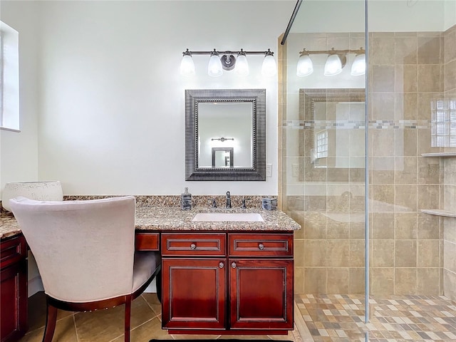 bathroom featuring a tile shower, tile patterned floors, and vanity