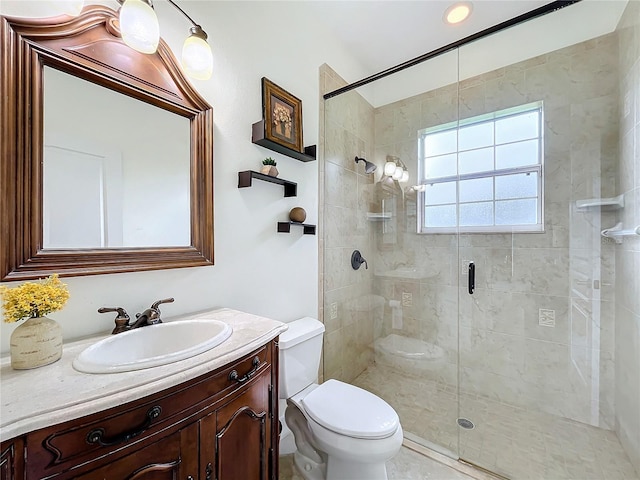 bathroom featuring walk in shower, vanity, and toilet