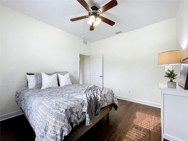 bedroom with ceiling fan and dark wood-type flooring