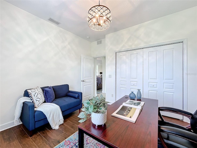 office space with a notable chandelier and dark hardwood / wood-style floors