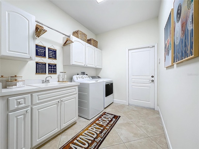 laundry area with cabinets, washing machine and dryer, light tile patterned floors, and sink