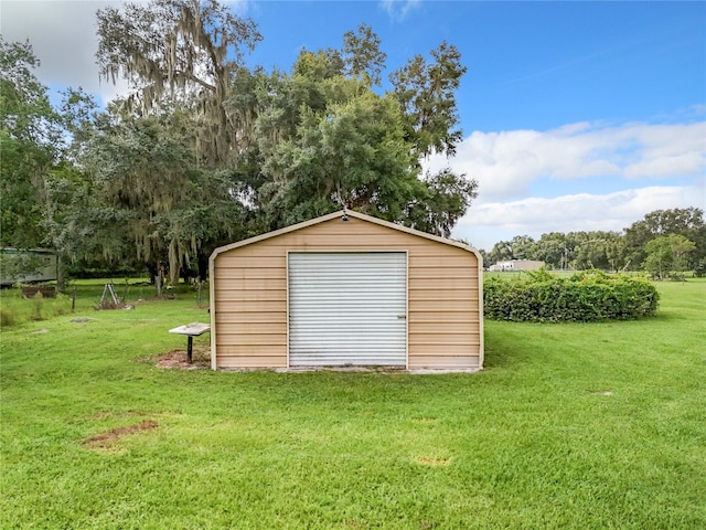 view of outbuilding with a yard