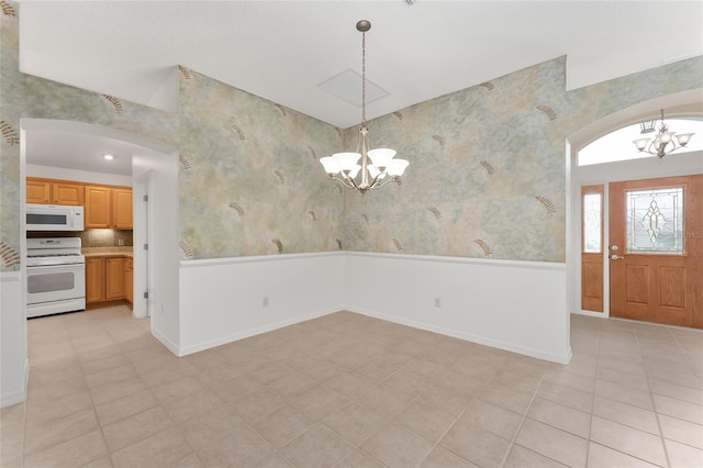 foyer with light tile patterned floors and a chandelier