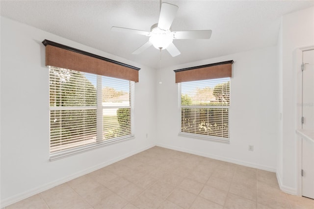 spare room featuring ceiling fan and a textured ceiling