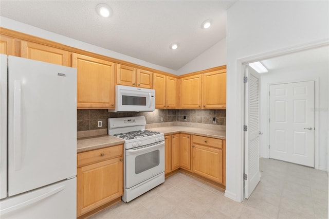 kitchen featuring lofted ceiling, light tile patterned flooring, a textured ceiling, white appliances, and tasteful backsplash