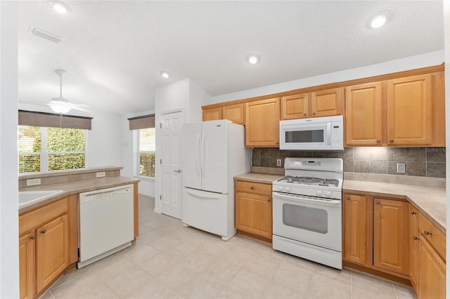 kitchen featuring white appliances, ceiling fan, decorative backsplash, and a textured ceiling