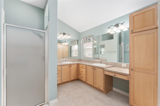 bathroom with vanity, vaulted ceiling, tile patterned flooring, and walk in shower