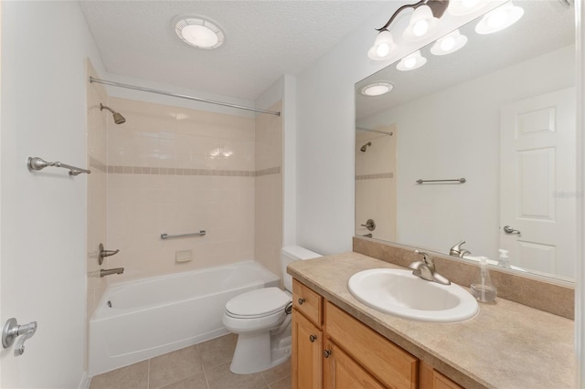 full bathroom featuring a textured ceiling, toilet, vanity, tiled shower / bath combo, and tile patterned floors