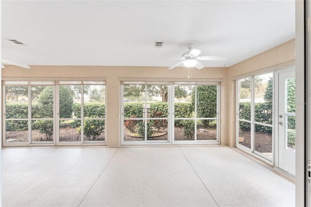 unfurnished sunroom with ceiling fan