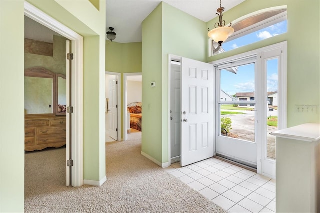 view of carpeted foyer entrance