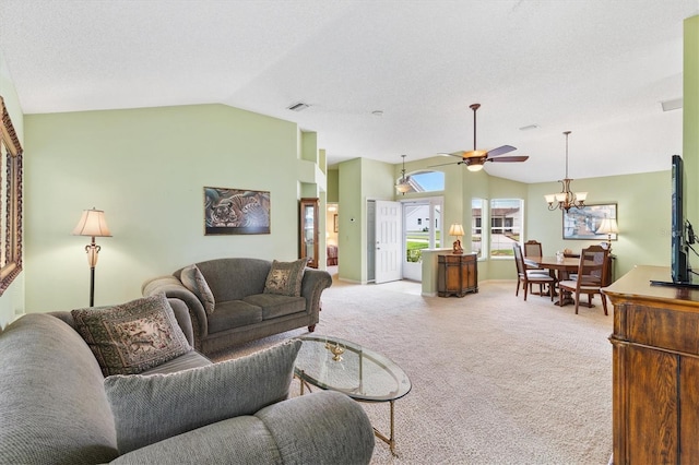 living room with a textured ceiling, ceiling fan with notable chandelier, lofted ceiling, and light colored carpet