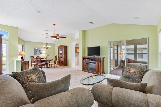 living room with ceiling fan, light colored carpet, and vaulted ceiling