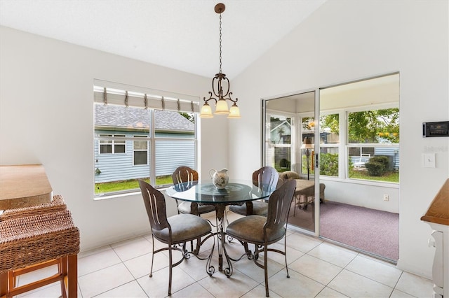 dining room featuring a notable chandelier, lofted ceiling, and light tile patterned floors