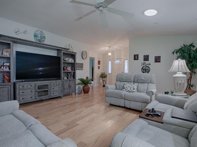 living room with vaulted ceiling, ceiling fan, and light hardwood / wood-style floors