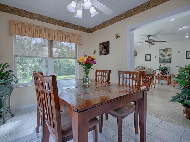 tiled dining room featuring ceiling fan