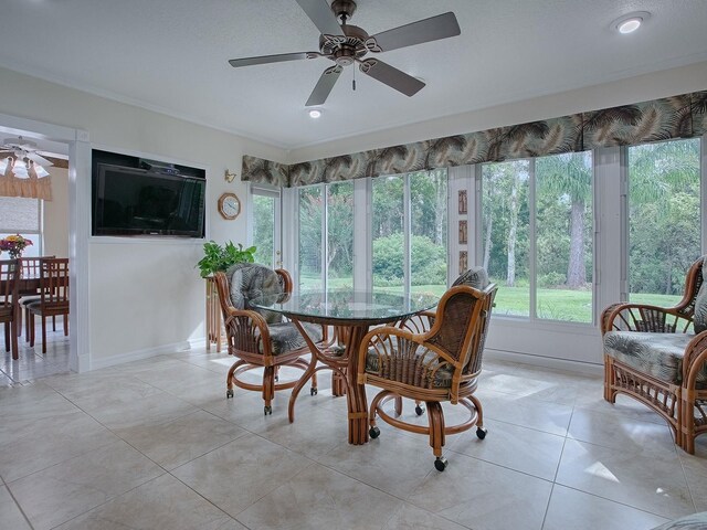 tiled dining area featuring a textured ceiling, ceiling fan, and ornamental molding