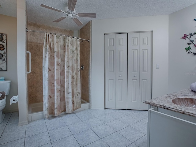 bathroom with toilet, walk in shower, vanity, a textured ceiling, and ceiling fan