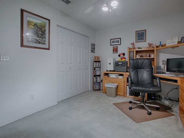 office space featuring light carpet and ceiling fan