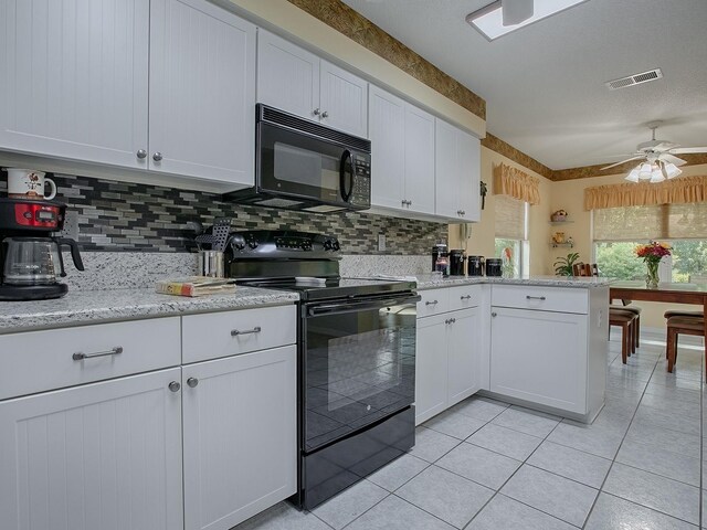 kitchen with white cabinets, black appliances, kitchen peninsula, ceiling fan, and decorative backsplash