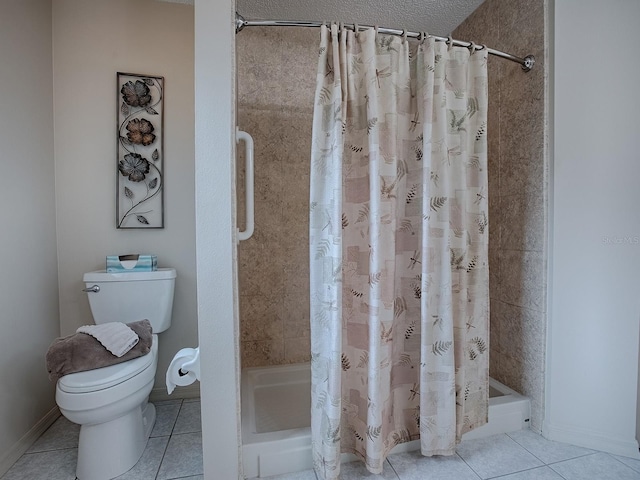 bathroom featuring toilet, curtained shower, tile patterned floors, and a textured ceiling