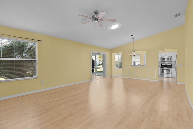 unfurnished living room with ceiling fan, light hardwood / wood-style floors, and vaulted ceiling