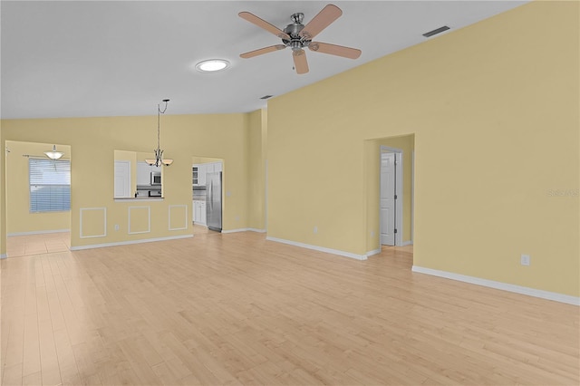 unfurnished living room featuring ceiling fan, vaulted ceiling, and light hardwood / wood-style flooring