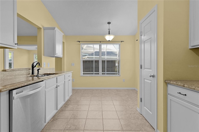 kitchen with stainless steel dishwasher, decorative light fixtures, light stone countertops, and white cabinetry