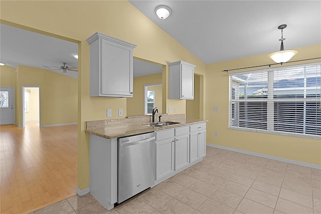 kitchen featuring light tile patterned flooring, vaulted ceiling, stainless steel dishwasher, and sink