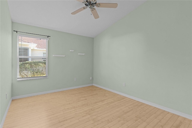 unfurnished room with ceiling fan, light hardwood / wood-style floors, and lofted ceiling