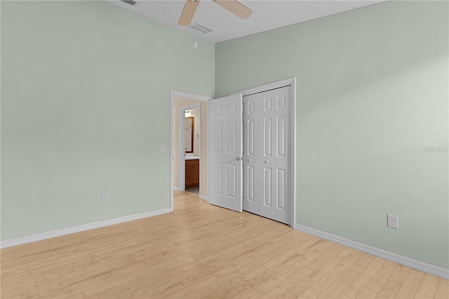 unfurnished bedroom with ceiling fan, a closet, and light hardwood / wood-style flooring