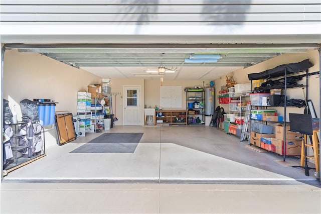 garage with gas water heater and a garage door opener