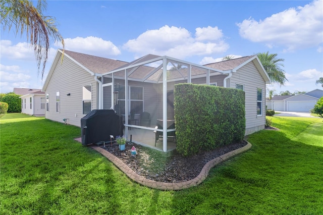 view of side of home featuring glass enclosure and a lawn