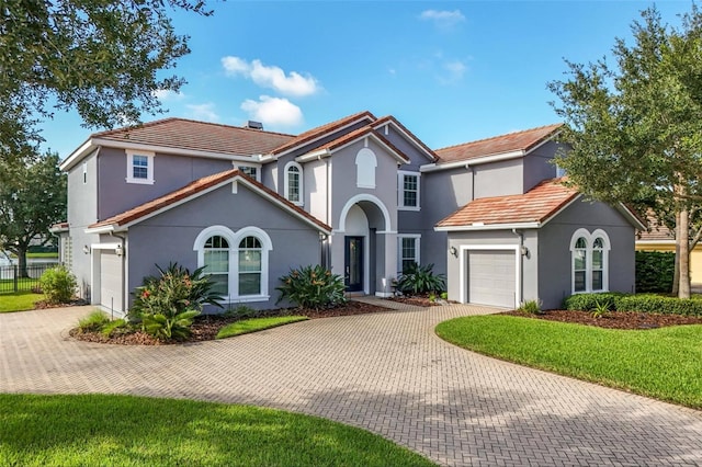 view of front of property with a front lawn and a garage