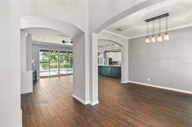 spare room featuring ceiling fan, dark hardwood / wood-style floors, and crown molding