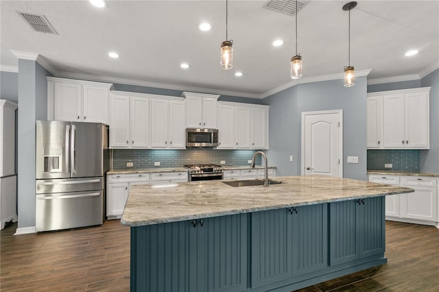 kitchen with stainless steel appliances, white cabinets, hanging light fixtures, and dark wood-type flooring