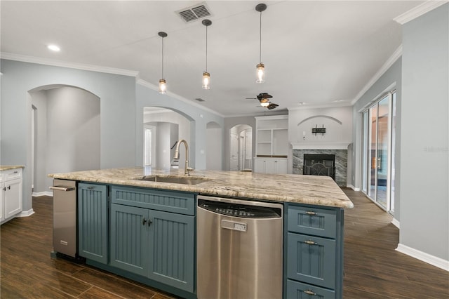 kitchen featuring hanging light fixtures, dark wood-type flooring, dishwasher, sink, and a premium fireplace