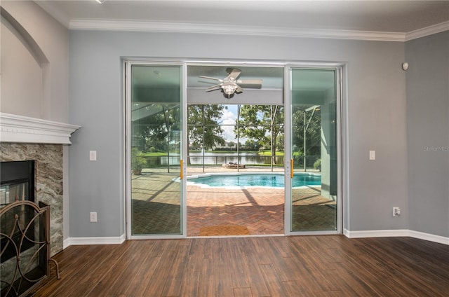 interior space with ceiling fan, crown molding, dark hardwood / wood-style flooring, and a high end fireplace