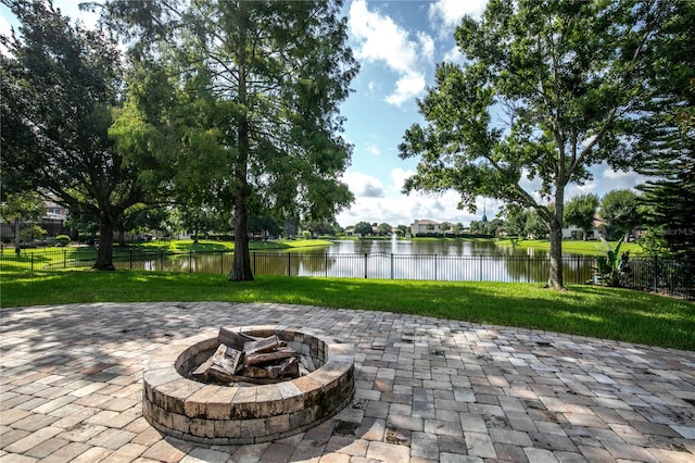 view of patio / terrace featuring a water view and a fire pit