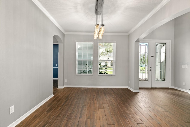 foyer entrance with ornamental molding, dark hardwood / wood-style flooring, and a notable chandelier