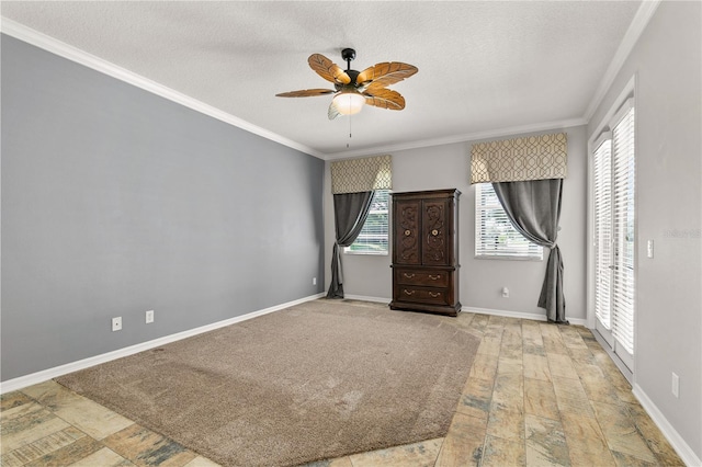 unfurnished room with a textured ceiling, crown molding, and ceiling fan