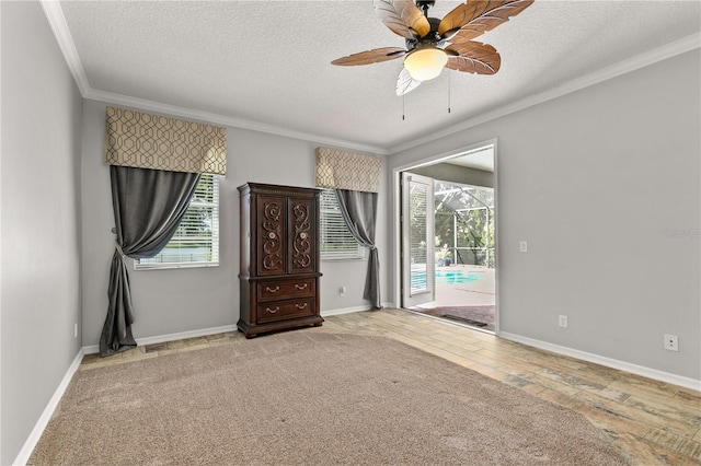 unfurnished bedroom with multiple windows, a textured ceiling, ceiling fan, and hardwood / wood-style flooring