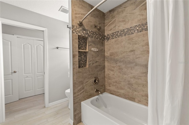 bathroom featuring toilet and shower / bathtub combination with curtain