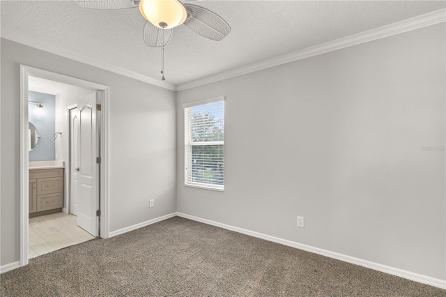 unfurnished bedroom featuring a textured ceiling, connected bathroom, ceiling fan, and light colored carpet