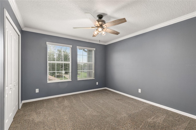 carpeted empty room featuring ceiling fan, a textured ceiling, and ornamental molding